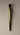 Brass cannabis joint rolling wand sitting on neutral colored background with cast shadow
